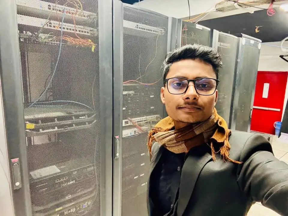 Awshan beside server racks